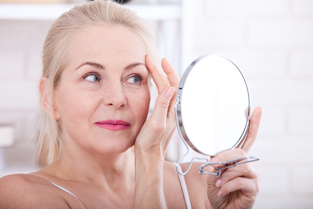 Canva Forty Years Old Woman Looking At Wrinkles In Mirror. Plastic Surgery And Collagen Injections. Makeup. Macro Face. Selective Focus 1024x683