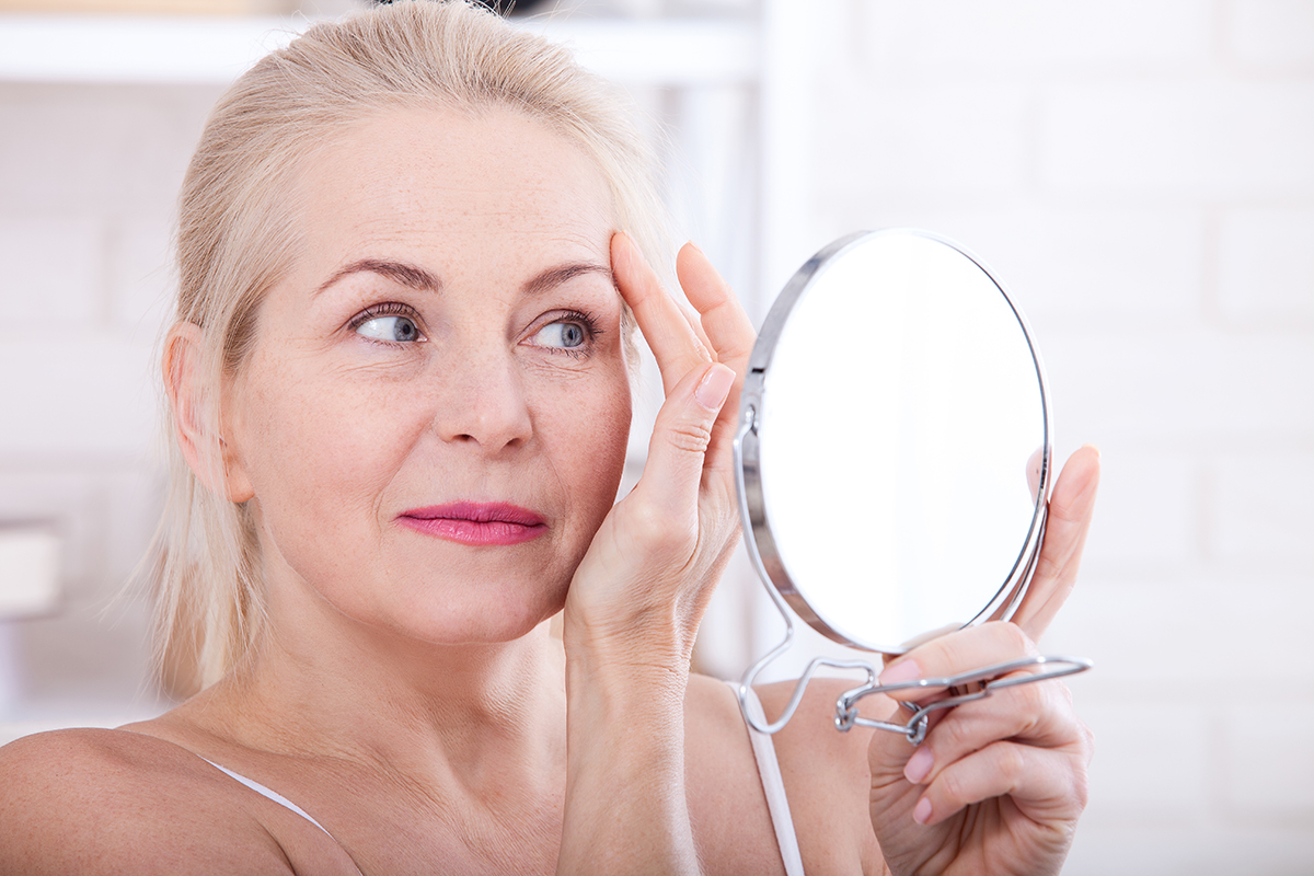 Canva Forty Years Old Woman Looking At Wrinkles In Mirror. Plastic Surgery And Collagen Injections. Makeup. Macro Face. Selective Focus
